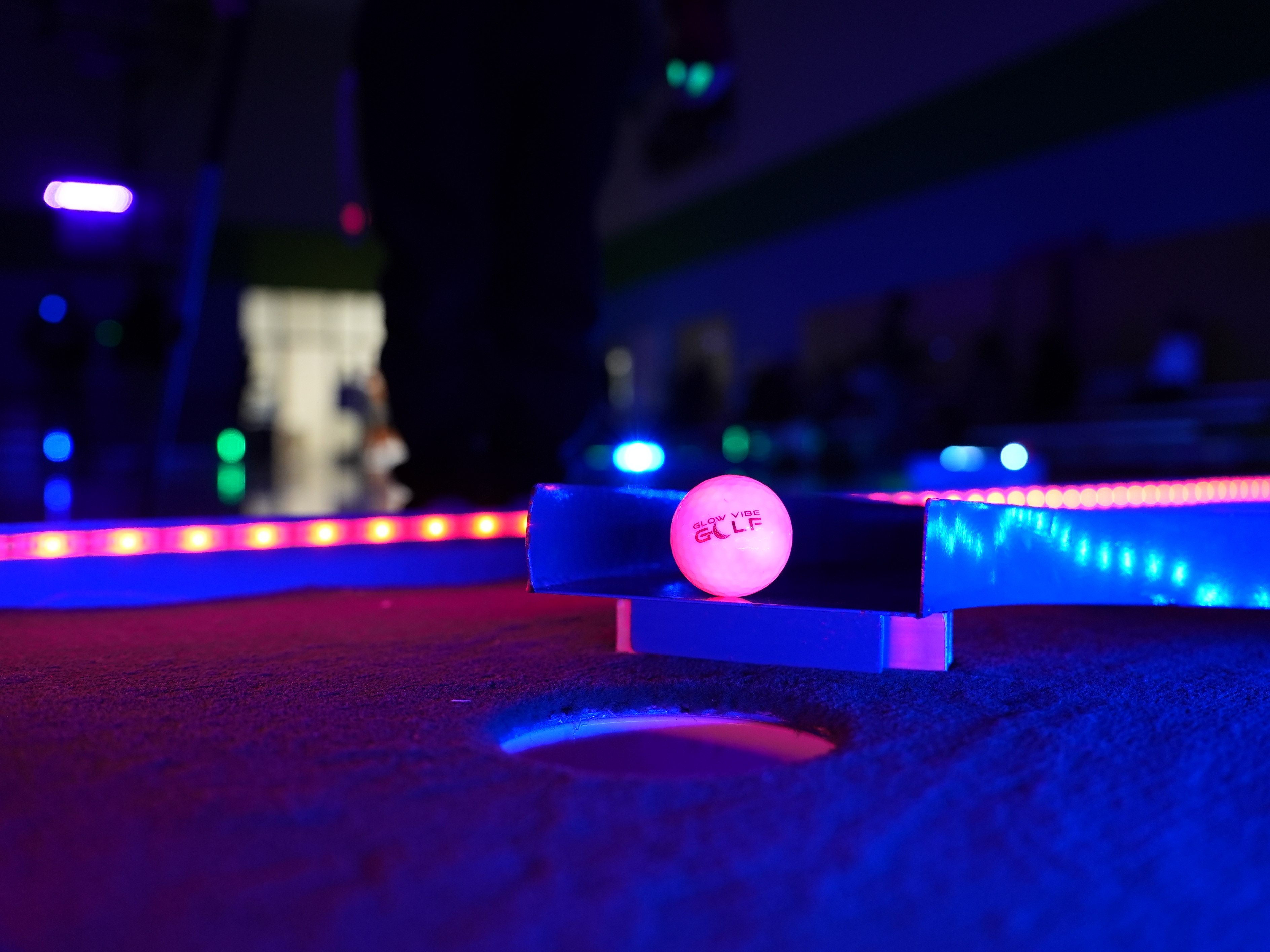 Glow in the dark mini golf course at night