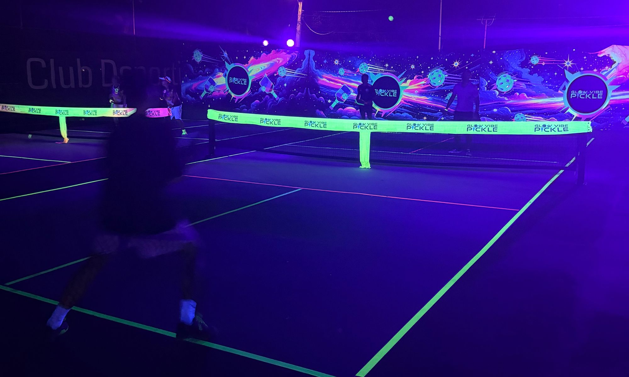 Glow pickleball under the lights at night