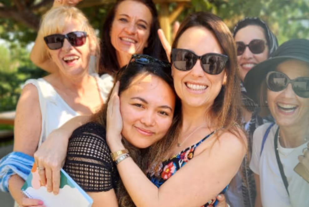 group photo of hey lady members outdoors at an event with the founder