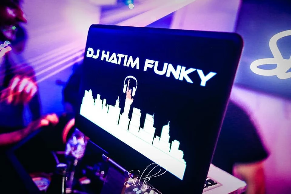 DJ Hatim Funky branding on a laptop at a DJ setup