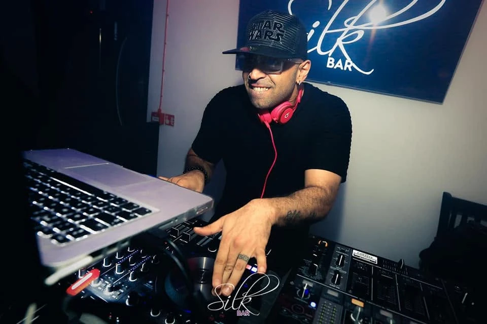 DJ Hatim Funky performing at the decks with red headphones