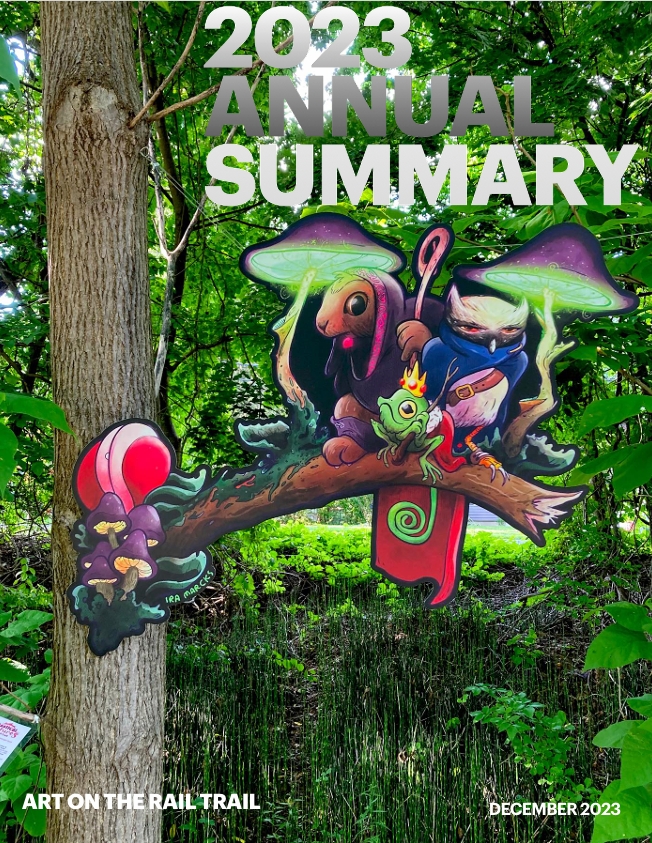 Cover of the 2023 ART Annual SUmmary, image of an art installation of three whimsical animal characters: rabbit, lizard, and owl and colorful mushrooms. The artwork is a flat panel hung in a tree on the rail trail. Clicking on the image will expand the pdf attachment of the 2023 annual summary.