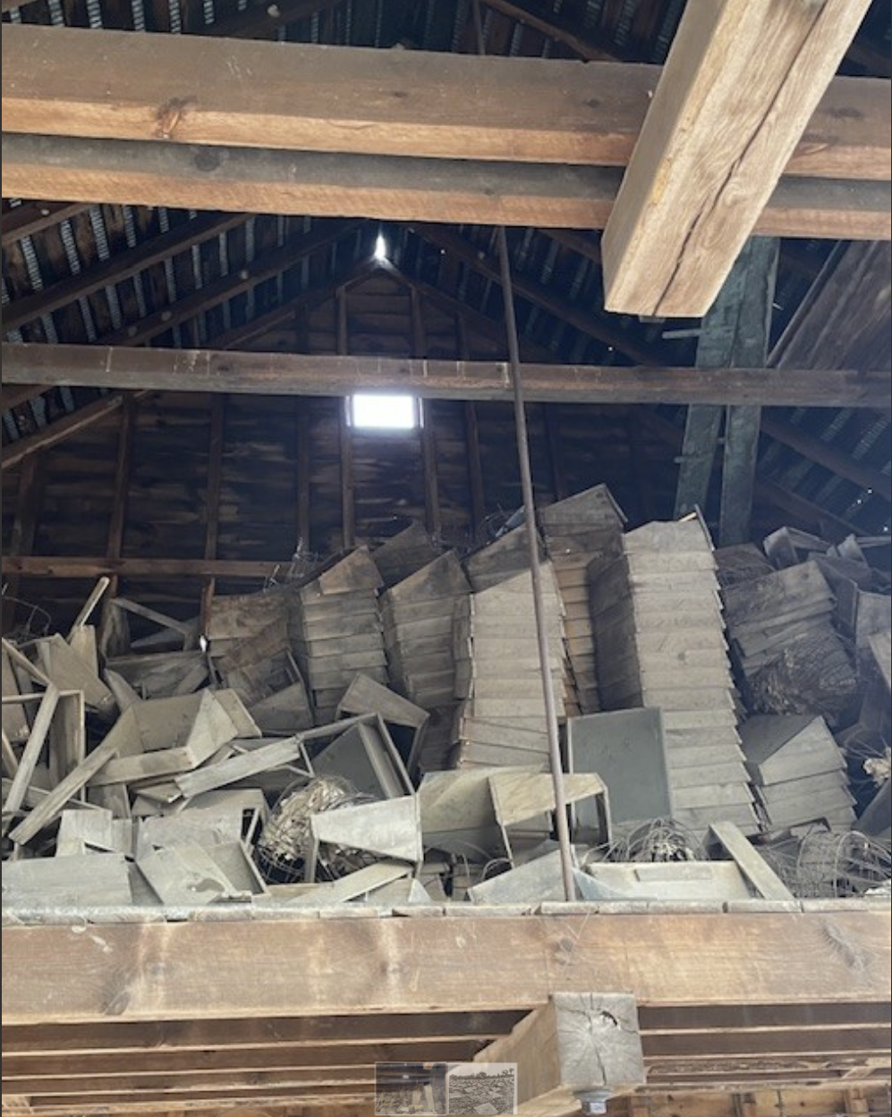 Photo shows stacks of old cold frames stored in the rafters of the barn at Bender Melon Farm