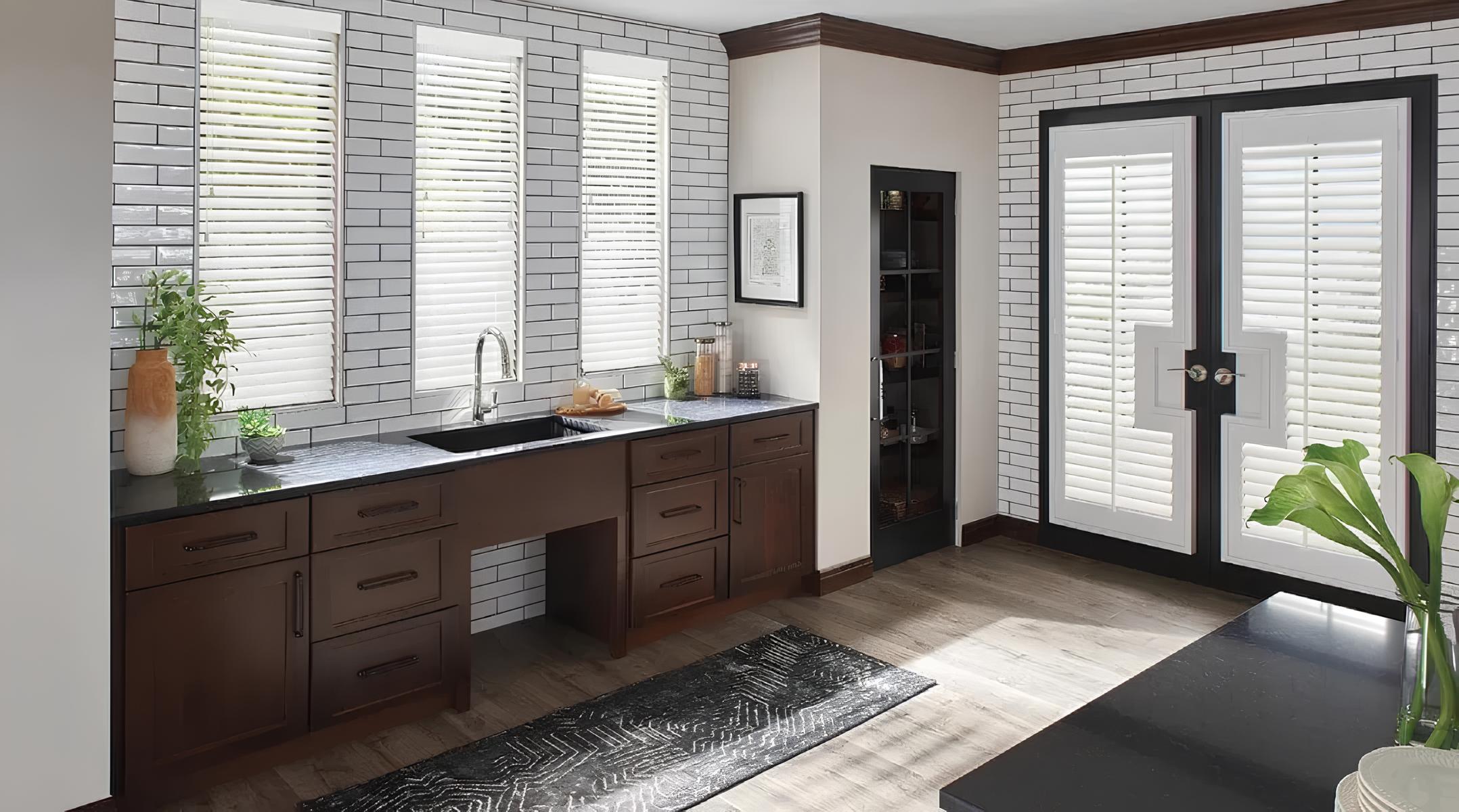 Kitchen with dark wood cabinets, black countertop, and white brick tiles.