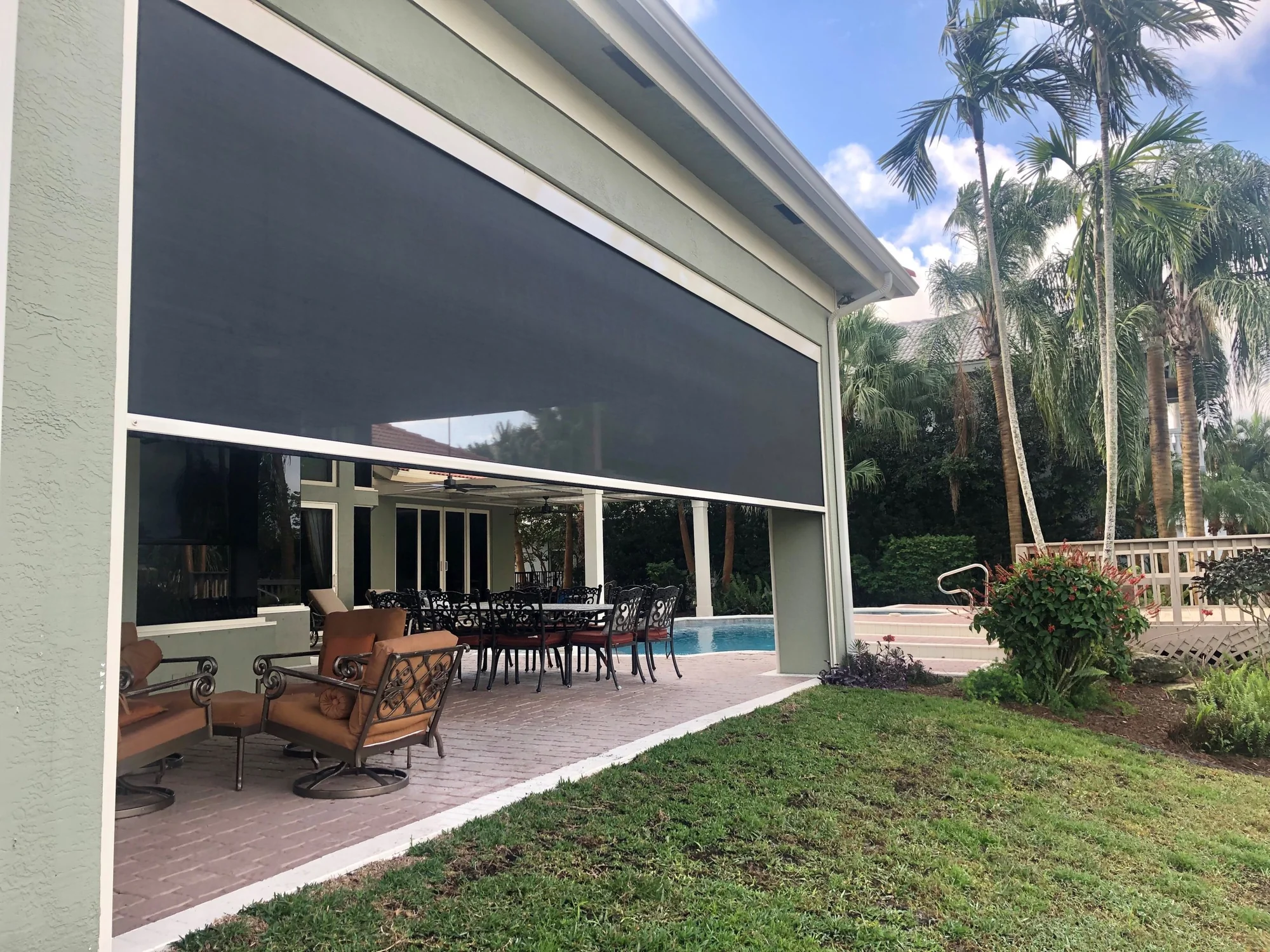 Residential retractable shade screen installation for outdoor living area