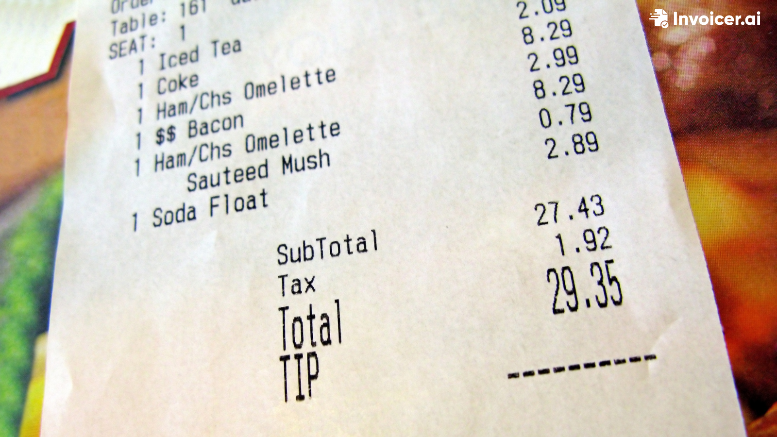 A person filling in an invoice with a calculator in the foreground