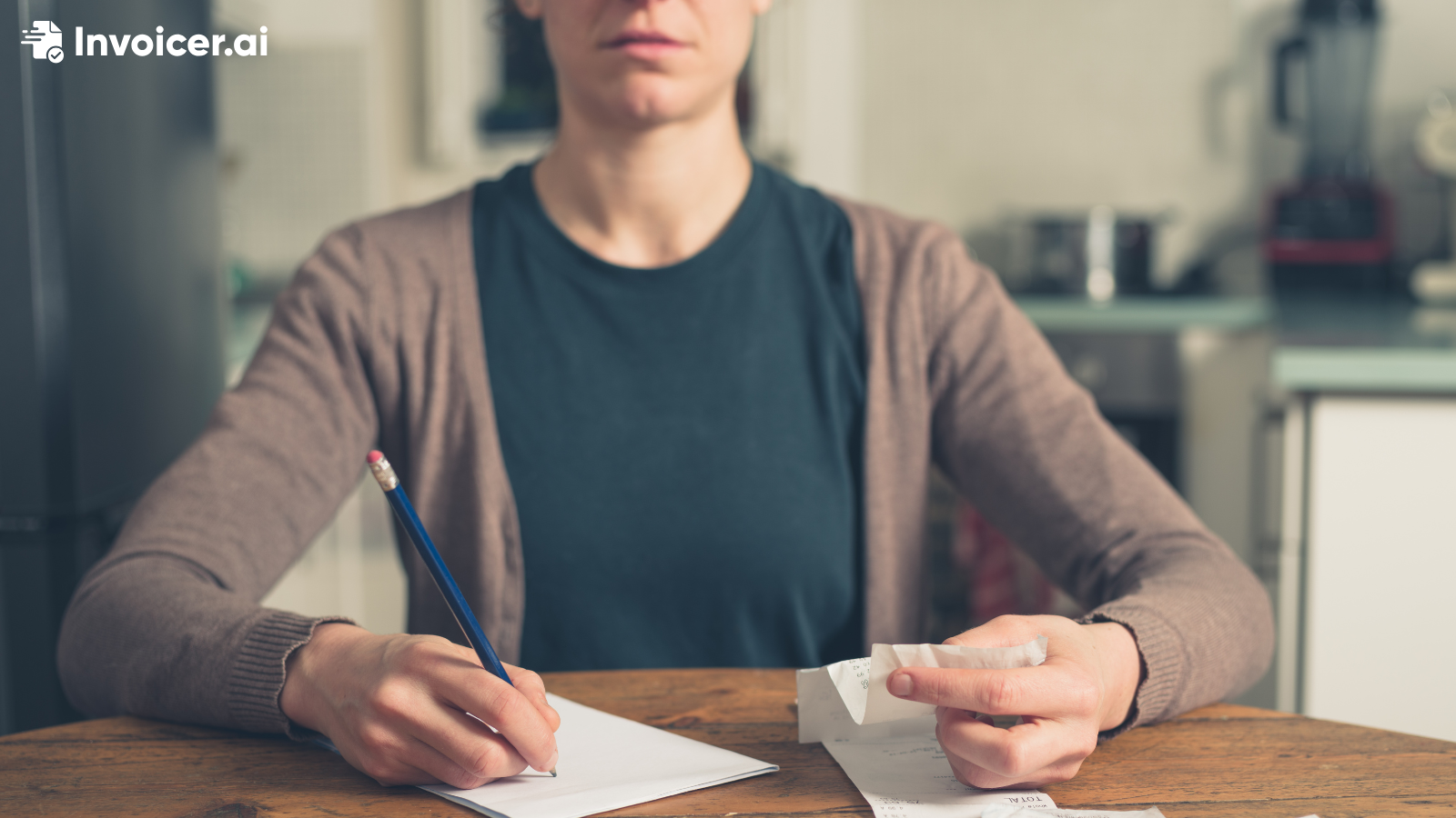 A person filling in an invoice with a calculator in the foreground