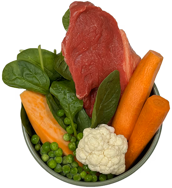 Fresh ingredients for Frisp dog food — beef, vegetables, and spinach ready to be cooked.