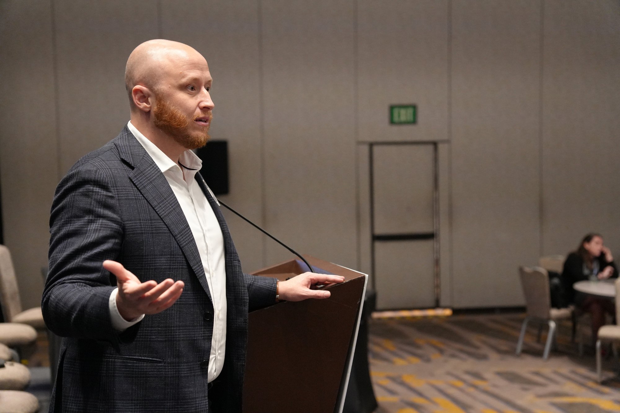 Tyler Wallace speaking to a conference audience