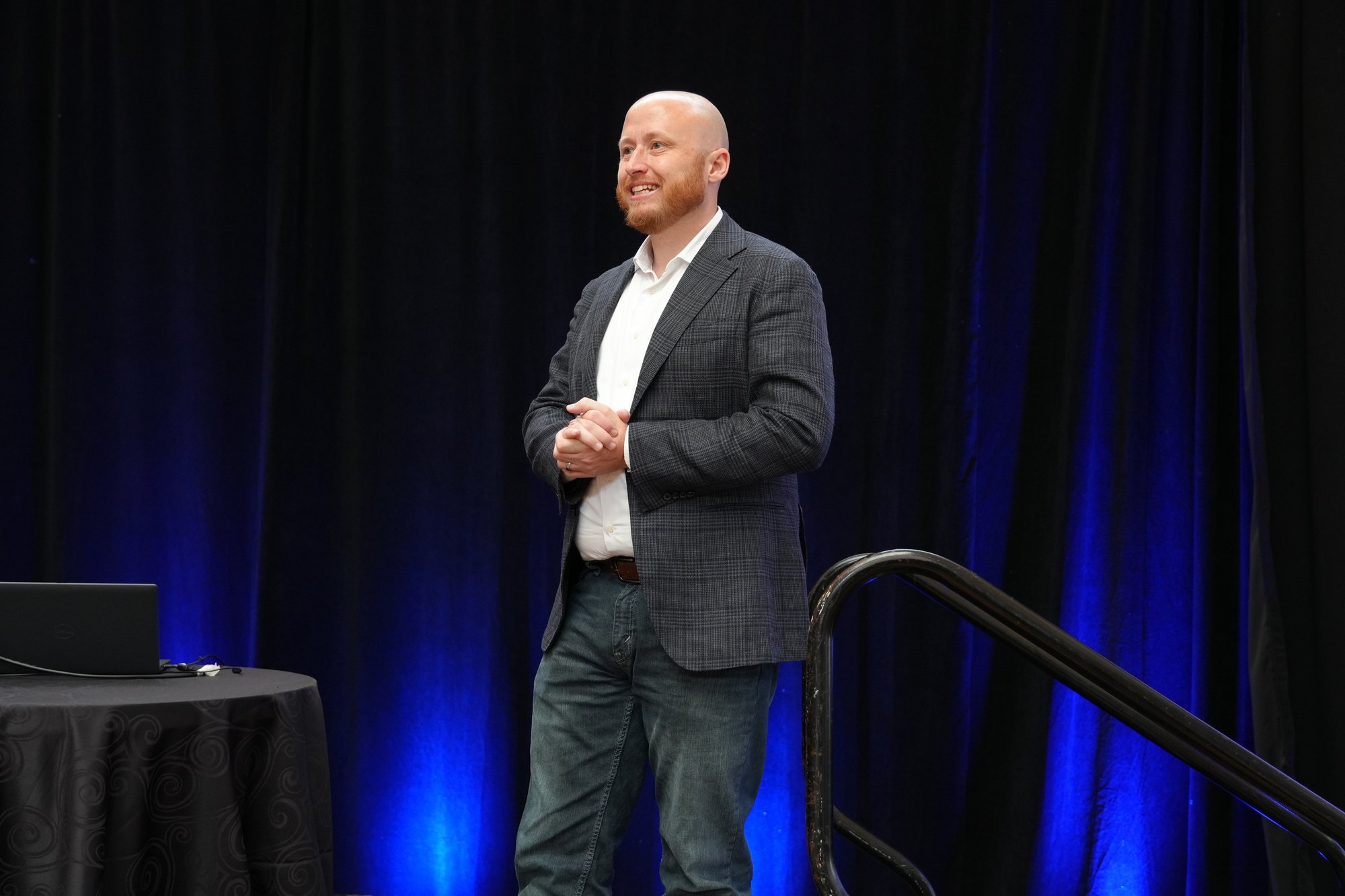 Tyler Wallace on stage delivering a keynote