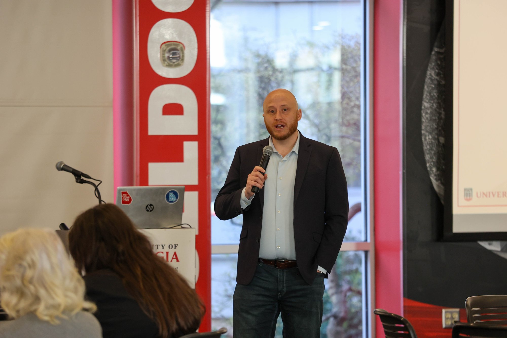 Tyler Wallace speaking at a podium during a healthcare conference