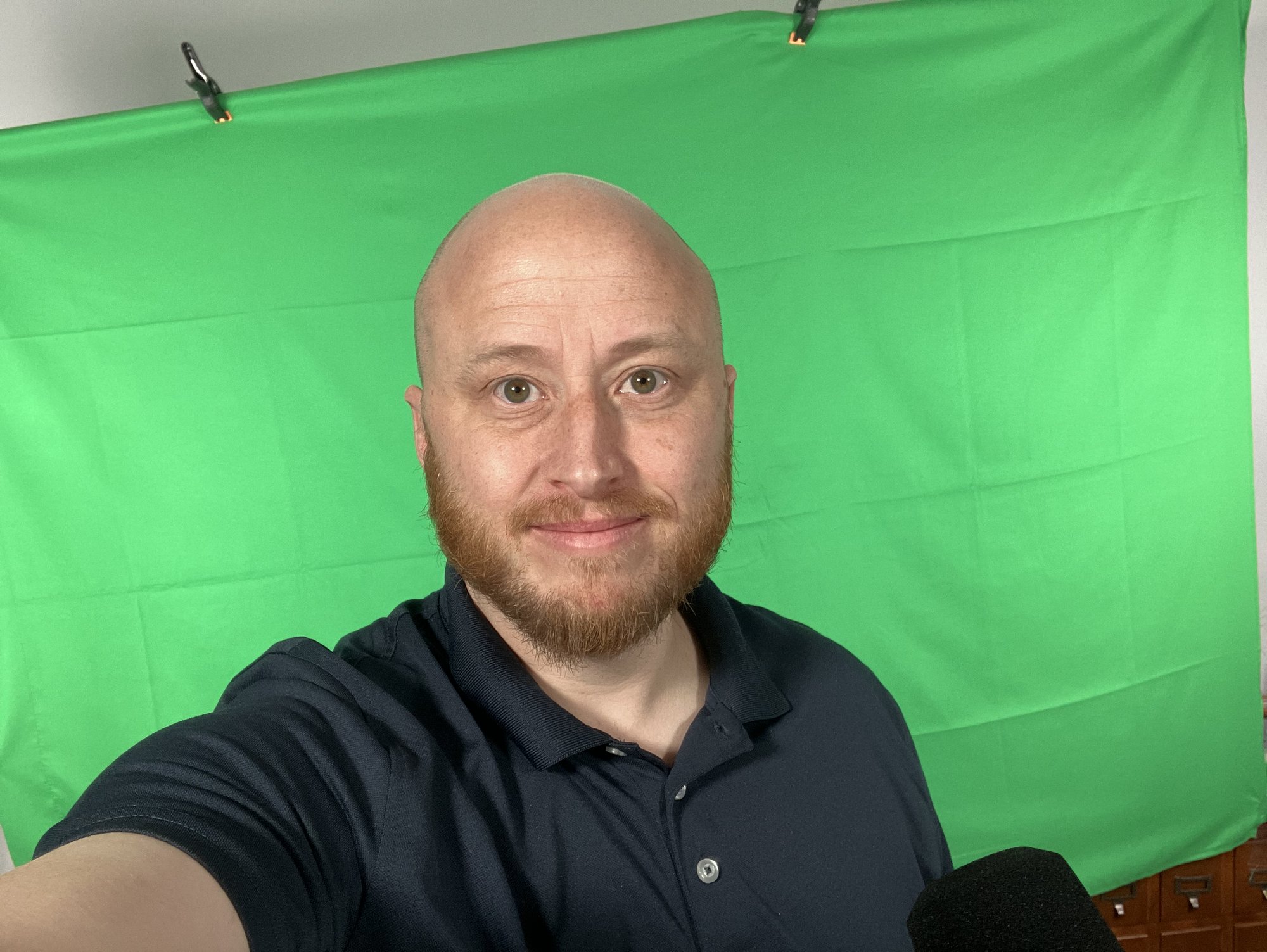 Tyler Wallace recording training video in front of a green screen
