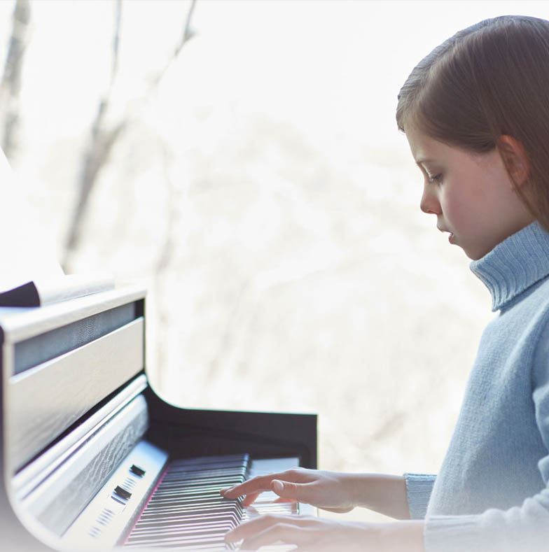 Young girl practices on a Roland piano