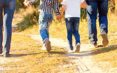 Legs and feet of a family walking outside. Average cost of private bunion surgery in UK.
