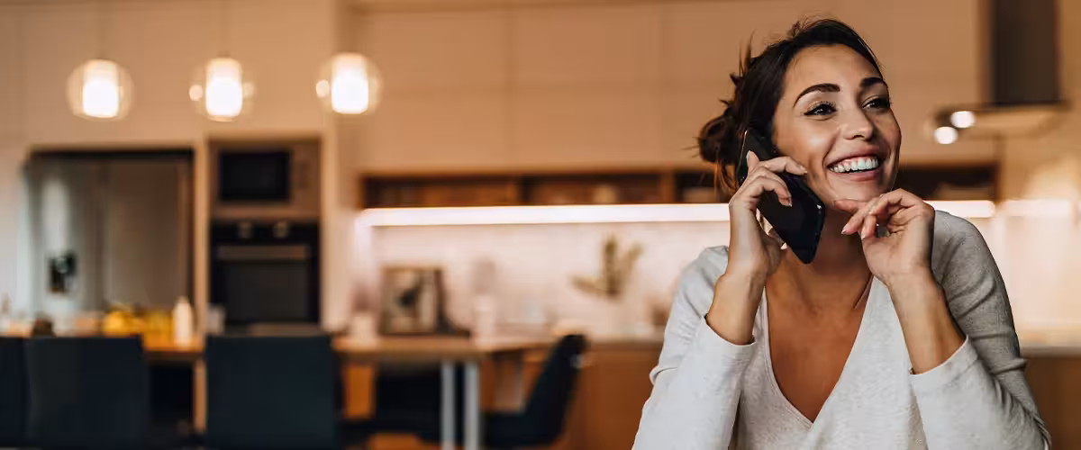 Women talking with someone over the phone. Your Guide To Getting A GP Referral In The UK