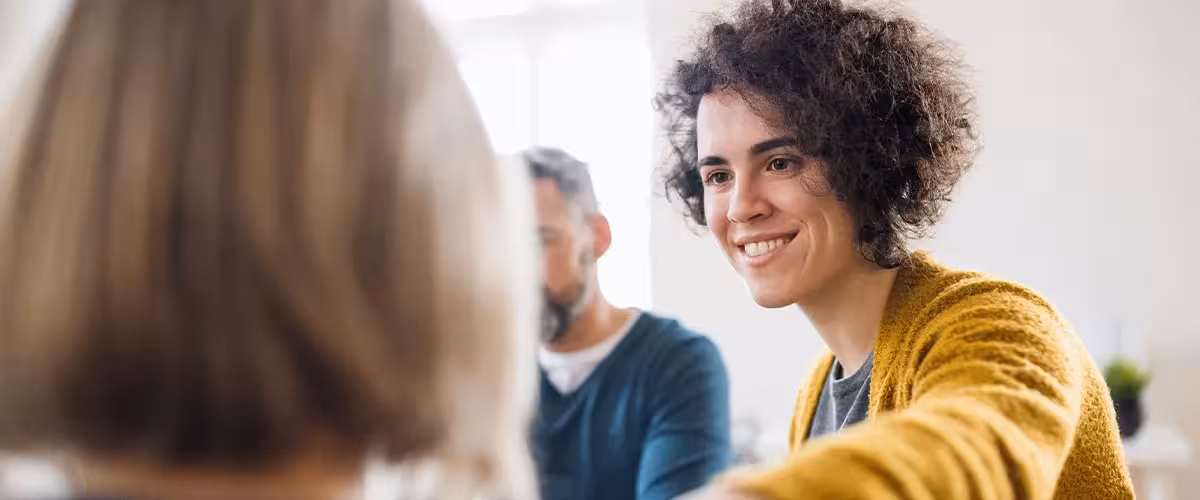 Men and women sitting in a circle during group therapy, supporting each other. How Much Demand Is There On Mental Health Services In The UK?
