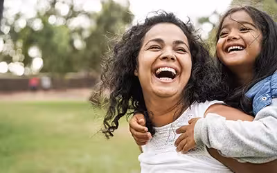 Happy mother having fun with her daughter outdoor. How Is Lifestyle Affecting Health In The UK?