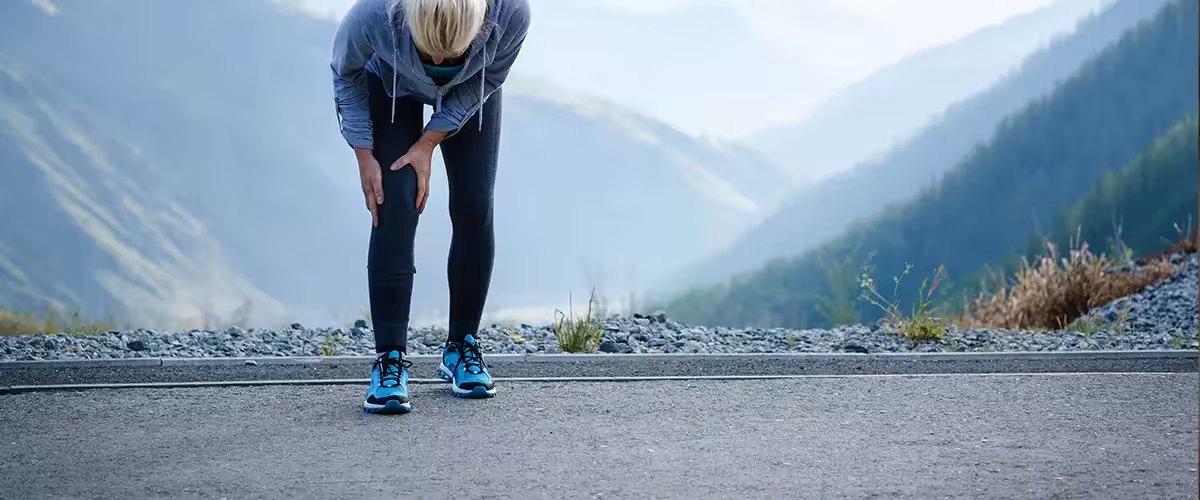 Injuries - sports running knee injury on woman. Average Private Knee Arthroscopy Cost In The UK