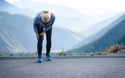 Injuries - sports running knee injury on woman. Average Private Knee Arthroscopy Cost In The UK