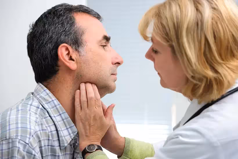Patient being examined for suspected tonsillitis