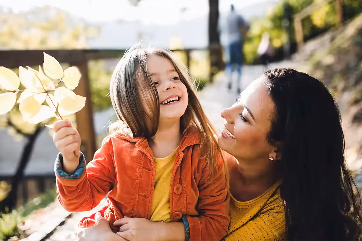 A portrait of young mother with a small daughter in autumn nature. How Does Life Insurance Work For Mums In The UK?