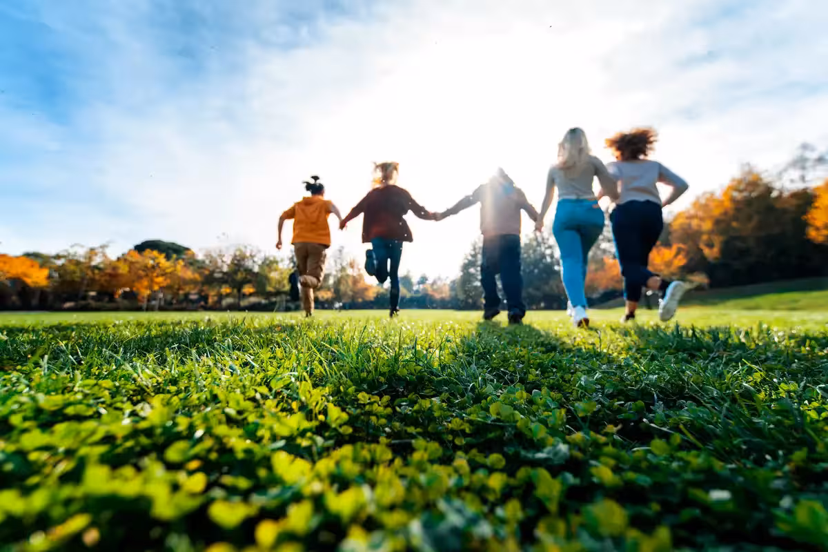 Family of five running in the park. 8 Different Types of Life Insurance.