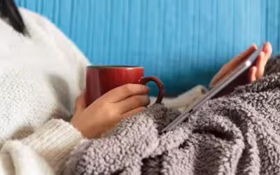 cosy scene with blanket hot drink and tablet
