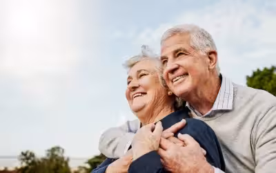 happy older couple in the sun looking forward