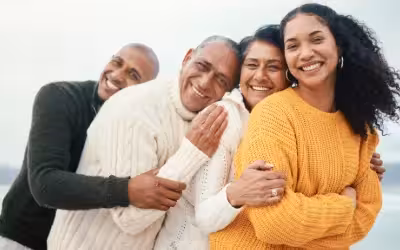 mature parents with adult children hugging smiling family