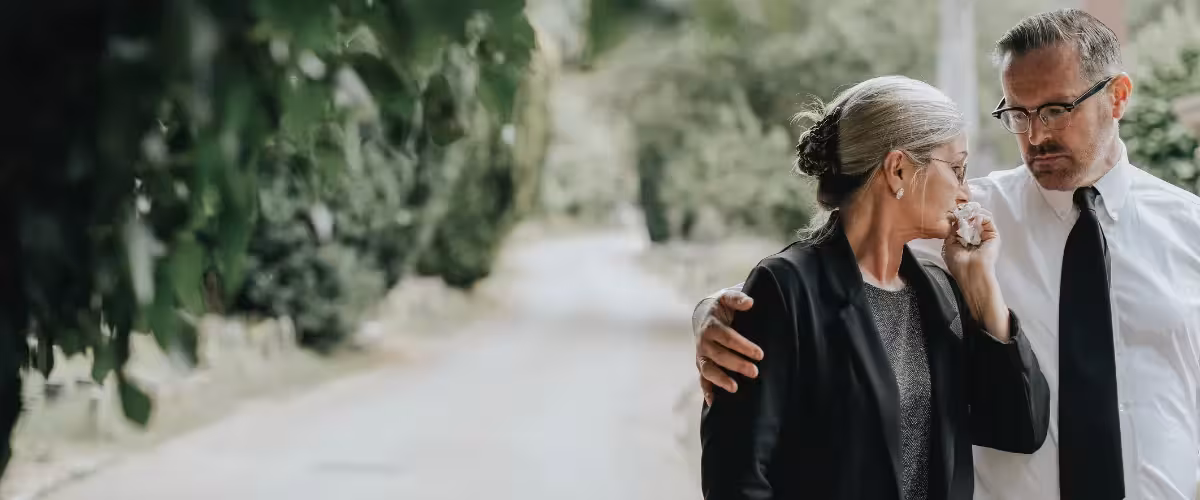 couple grieving at funeral