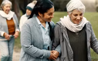 Nurse walking with patient outside. What Is An NHS Cash Benefit?