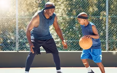 Father and Son playing basketball together to stay fit and healthy. 13 Top Tips For A Healthy Lifestyle.