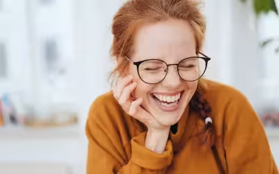 Smiling woman with glasses and white teeth