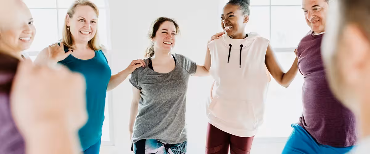 Diverse group of people stretching before class. How to get cheap medical insurance.