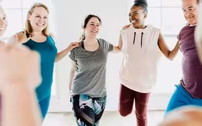 Diverse group of people stretching before class. How to get cheap medical insurance.