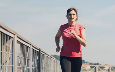 Middle aged woman running to keep fit and healthy