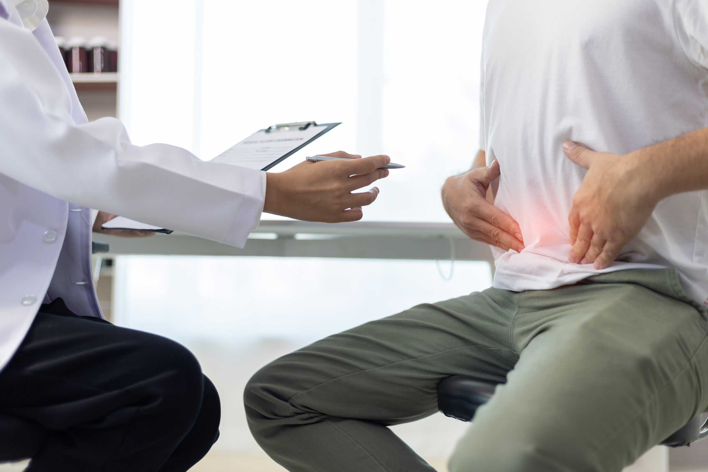 Consultant explaining a gastroscopy procedure to a patient before private treatment