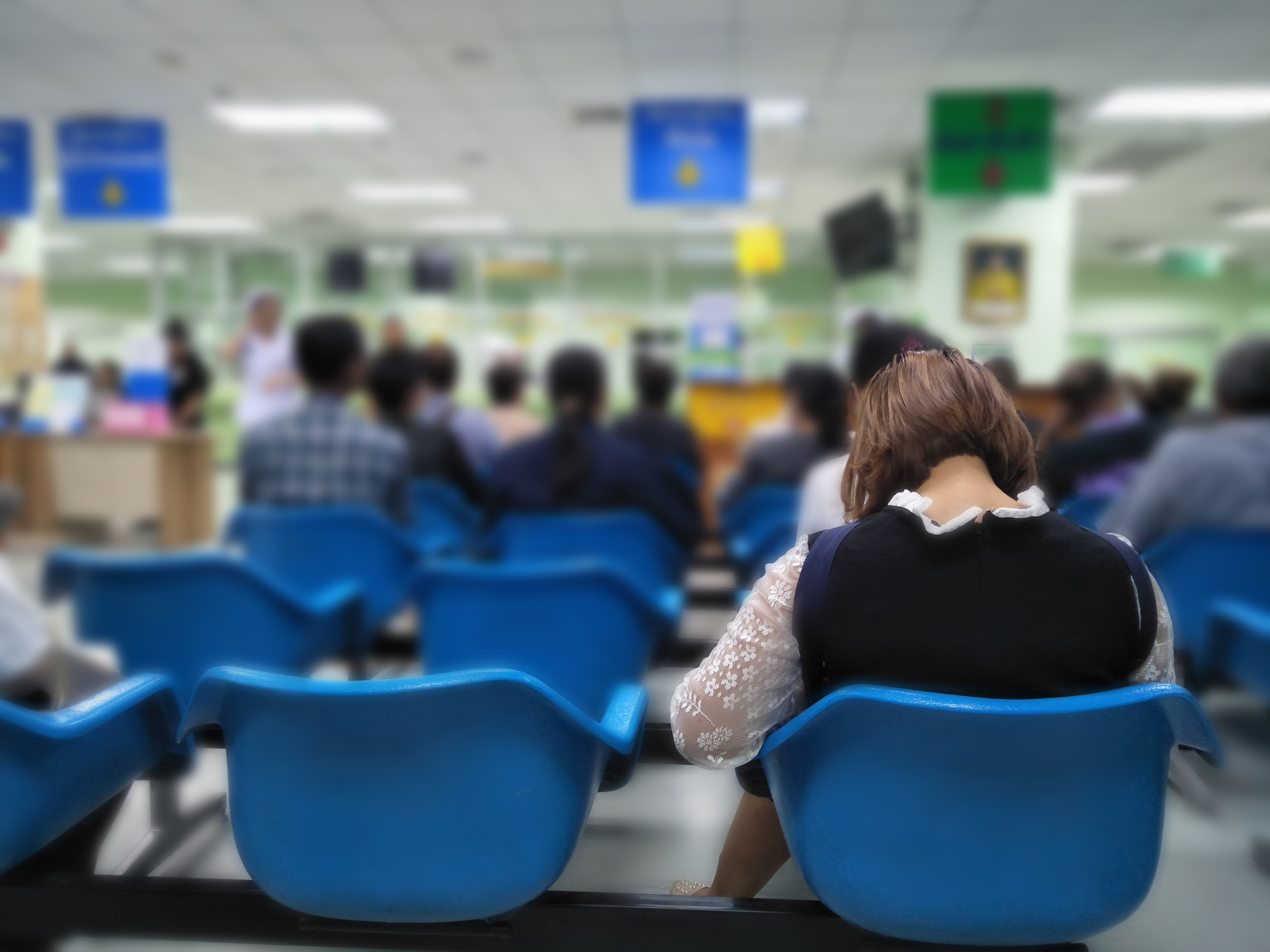 Patients waiting in an NHS hospital waiting room for their appointments