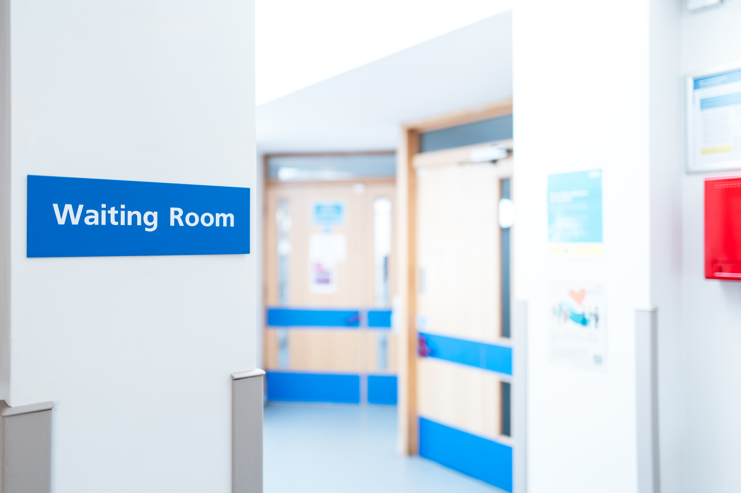 Patient waiting for an NHS mental health appointment in a hospital corridor