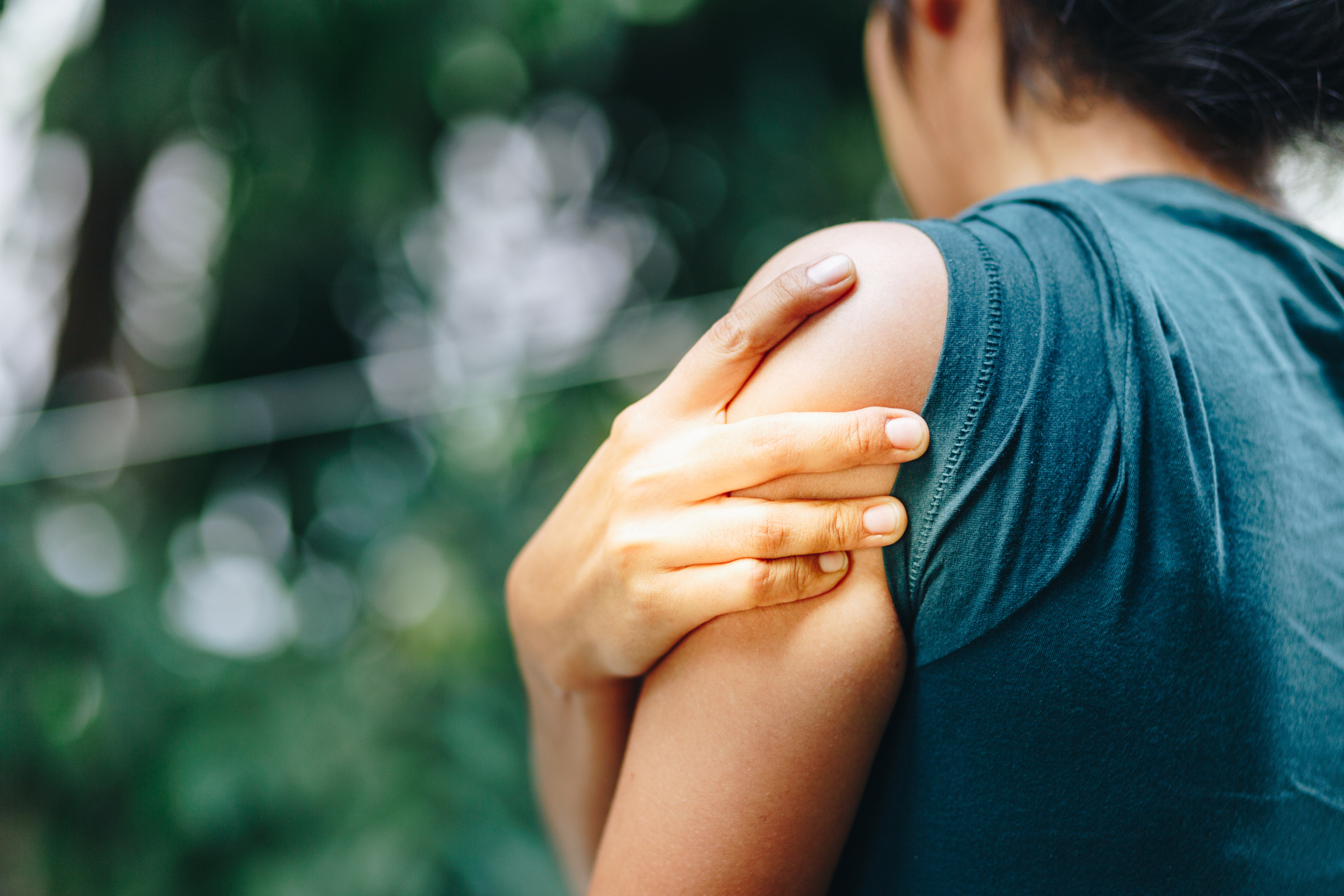 Orthopaedic specialist examining a patient's shoulder before private replacement surgery