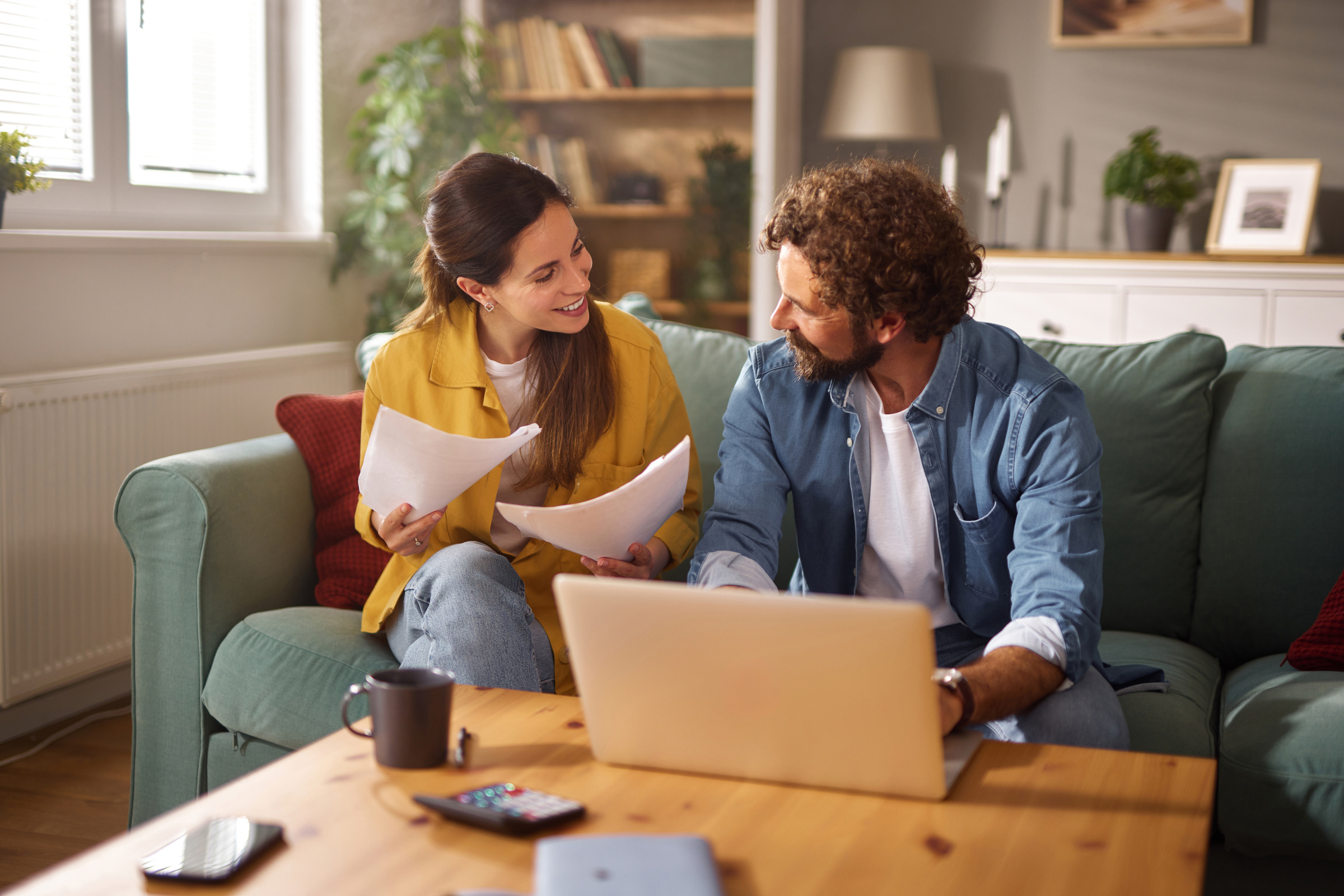 Person comparing two separate life insurance policies at a desk at home