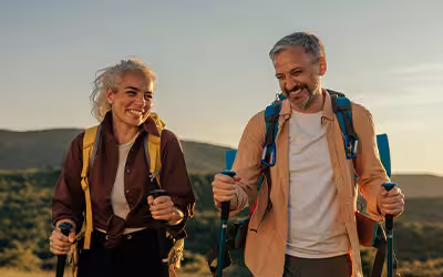 Claude responded: Two hikers smiling and walking outdoors with backpacks and trekking poles, green hills behind them, with the "Lateral" logo overlaid on the image.Two hikers smiling and walking outdoors with backpacks and trekking poles, green hills behind them, with the "Lateral" logo overlaid on the image.