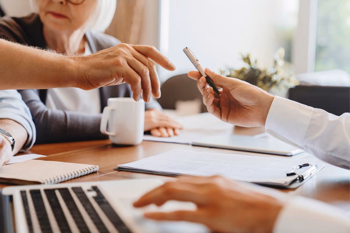 Couple reviewing inheritance tax paperwork with a financial adviser