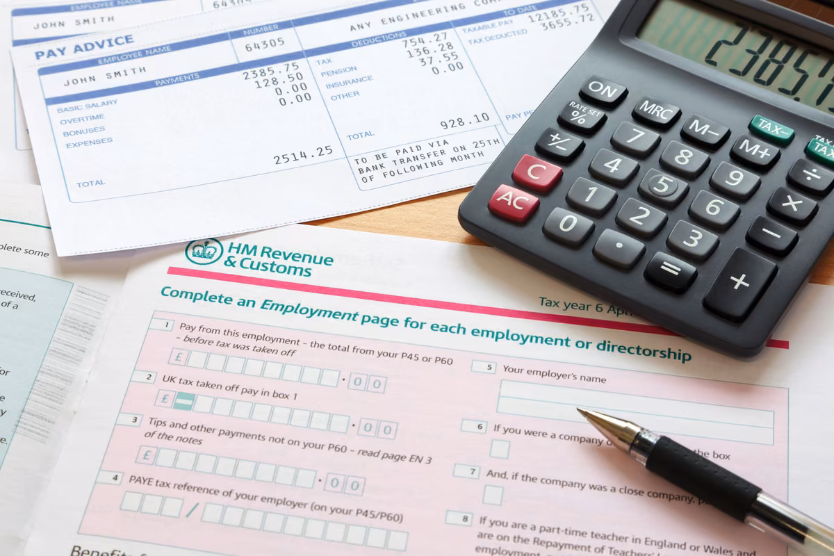 Person reviewing tax paperwork alongside a life insurance policy at home