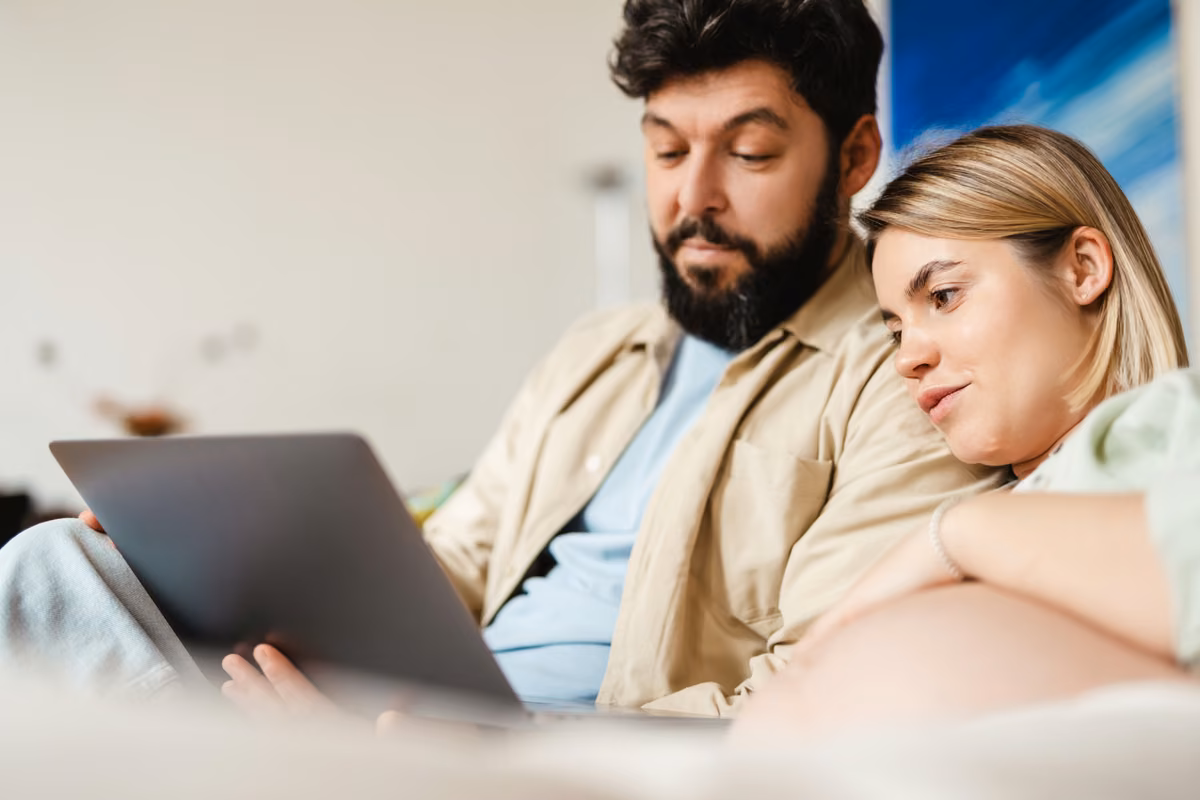 Couple reviewing life and critical illness cover options with an adviser
