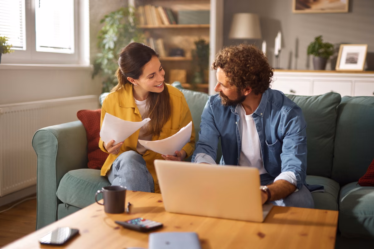 Person comparing two separate life insurance policies at a desk at home