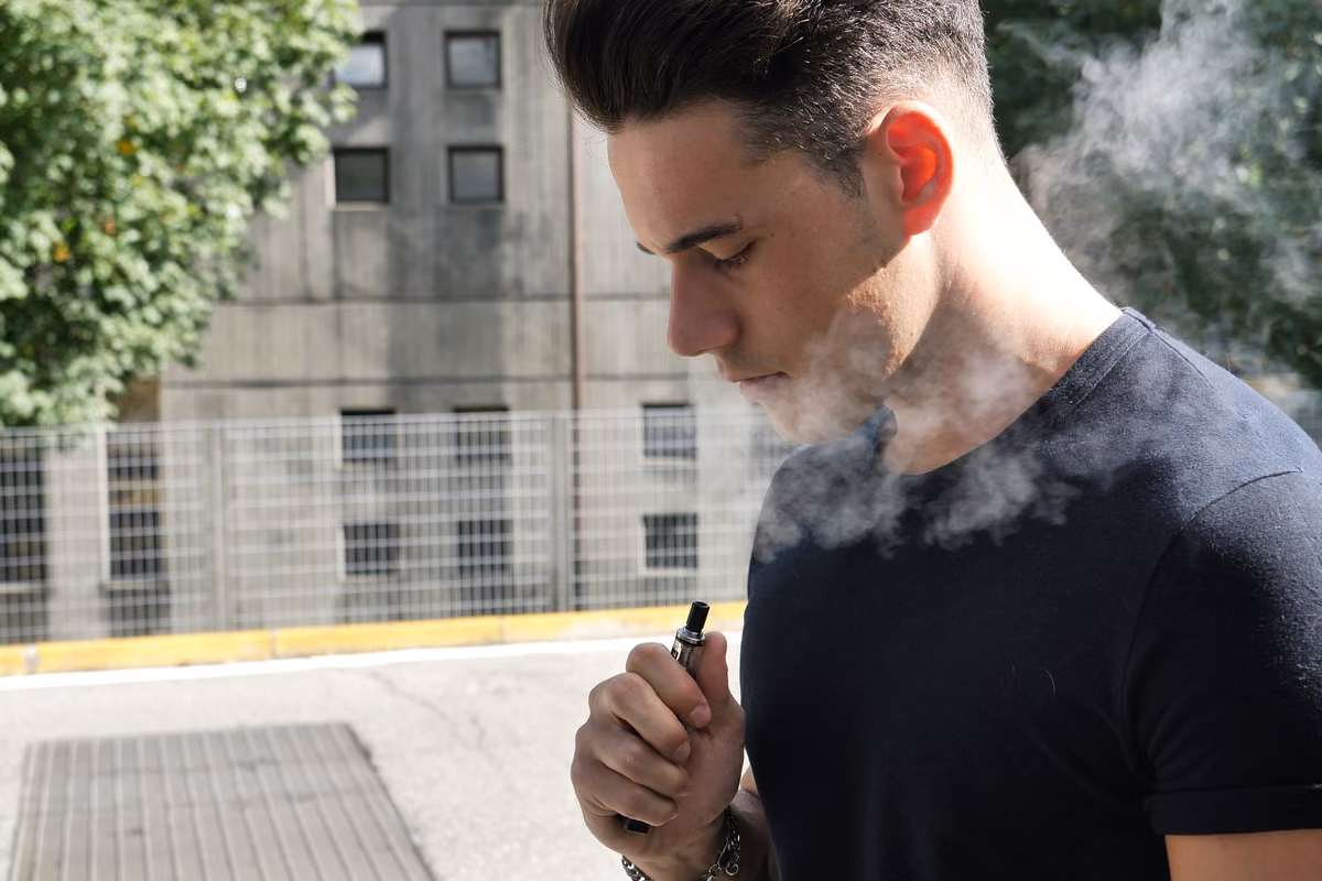 Person who smokes reviewing life insurance options and premiums at home