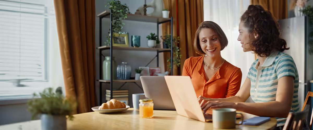 Two women smiling at a laptop at a breakfast table, with the Beagle Street.com logo overlaid.