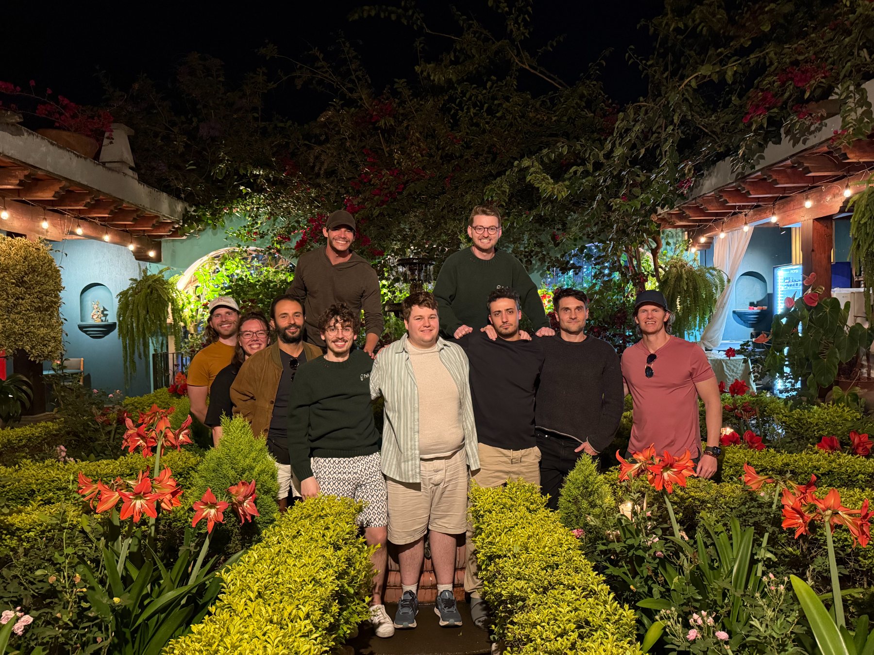 Park With Us team in a garden at night