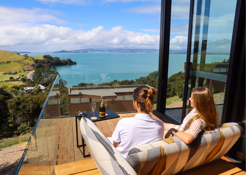 A couple enjoy Villa Serenity's balcony with an ocean view